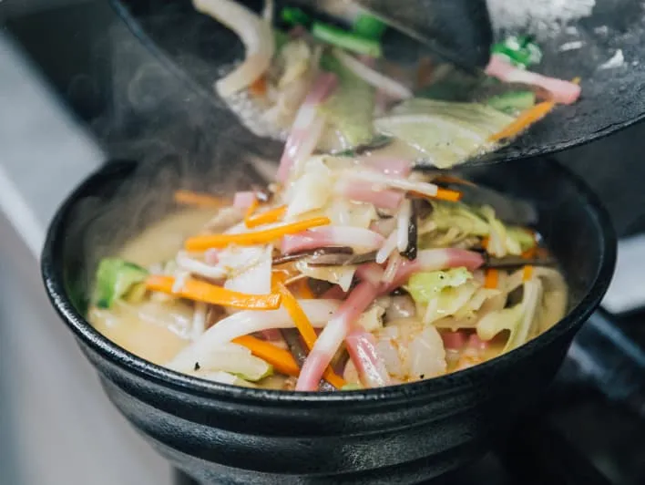 Cooking a vegetable mix in a pot.